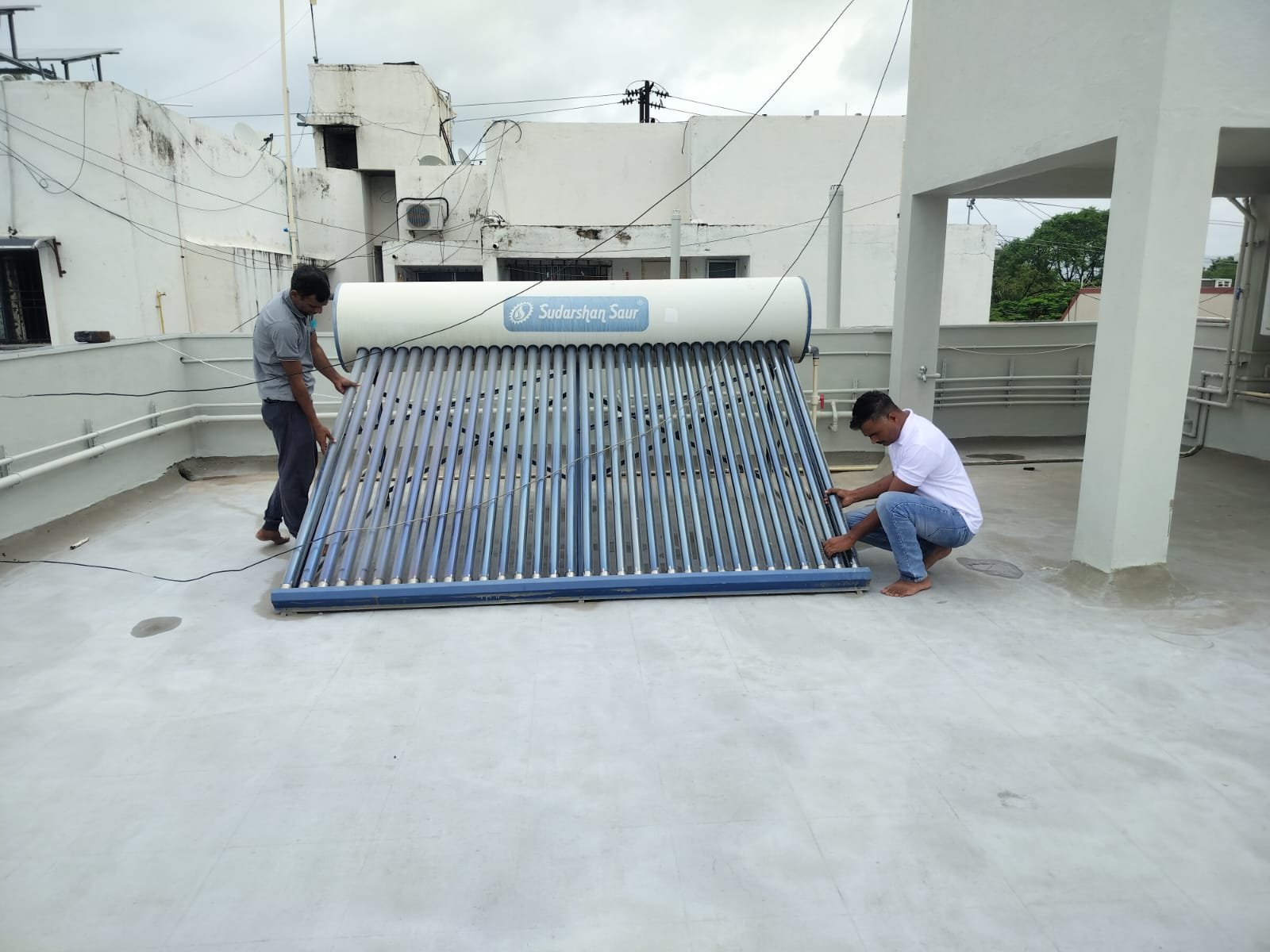 Ishwari technicians servicing a rooftop solar water heater