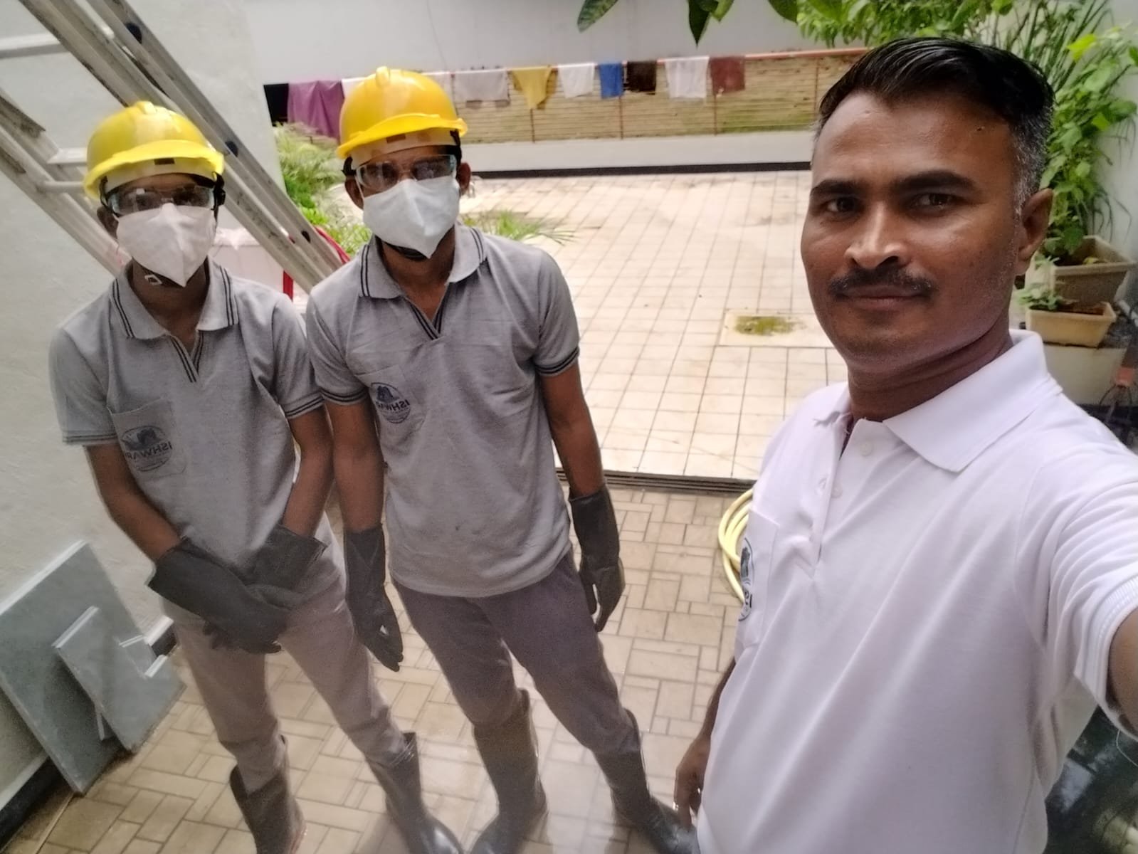 Ishwari cleaning team wearing protective equipment at a service site
